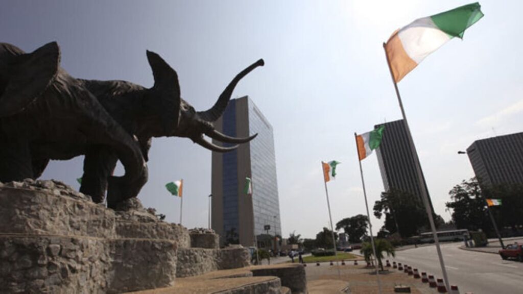 A monument with elephant statues and Ivory Coast flags are seen in Platau, the business center of Abidjan