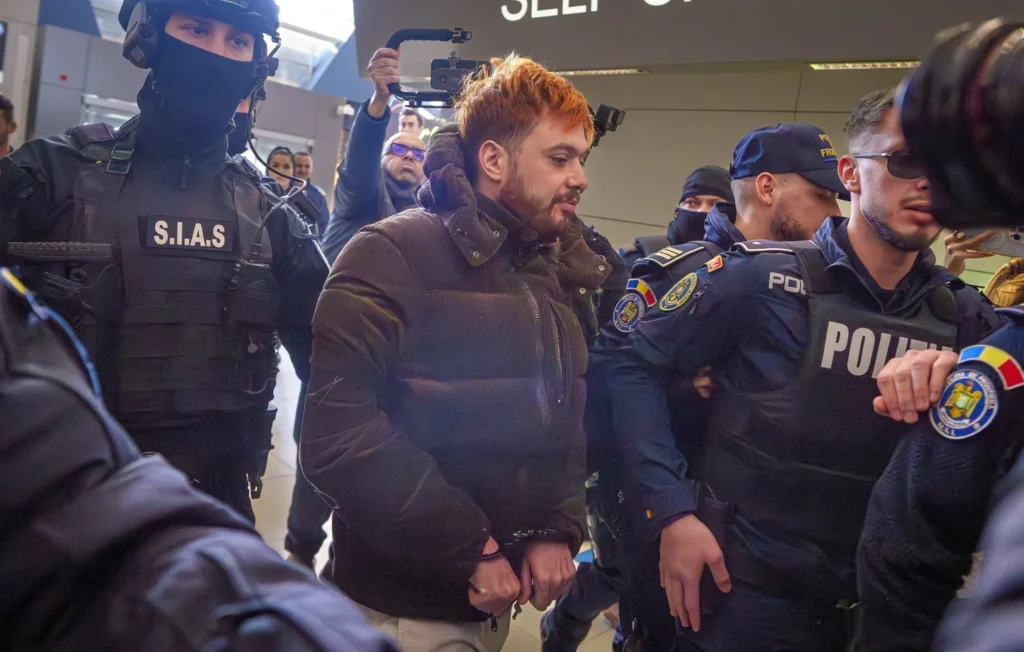 1444x920_mohamed-amra-nicknamed-the-fly-is-escorted-by-armed-police-officers-at-the-henri-coanda-international-airport-in-otopeni-romania-tuesday-feb-25-2025-before-being-extradited-to-france-ap-photo-vadim-ghirda-xvg102-25056521373874-250