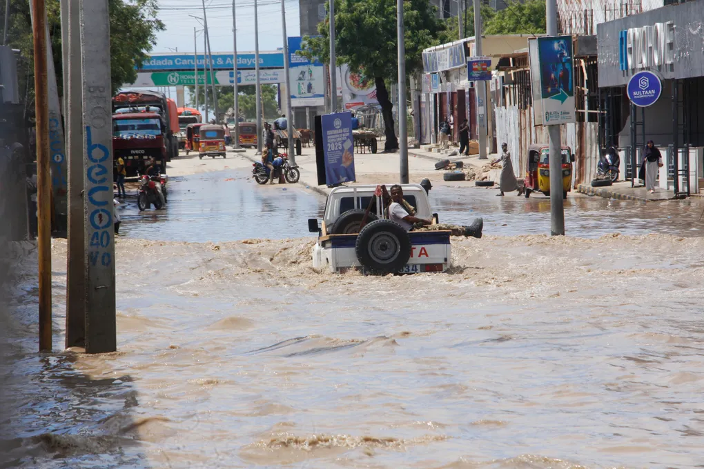 **Inondations à Mogadiscio : au moins sept morts après de fortes pluies** MOGADISCIO, 10 mai 2025 — Au moins sept personnes ont trouvé la mort dans la capitale somalienne vendredi soir, après que de fortes pluies ont provoqué d’importantes inondations, laissant certaines rues submergées jusqu’à la taille et paralysant les infrastructures de la ville. Selon Abdinasir Hirsi Idle, porte-parole de l’administration régionale, les précipitations ont duré près de huit heures, submergeant un système de drainage déjà saturé et affectant gravement plusieurs quartiers densément peuplés de Mogadiscio. « Le bilan pourrait s’alourdir », a-t-il déclaré à l’agence Associated Press samedi. « Neuf maisons se sont effondrées et au moins six routes principales ont été gravement endommagées. » Les autorités ont lancé des opérations de secours, toujours en cours samedi, tandis que certains habitants demeuraient piégés dans leurs habitations. « Nous avons passé la nuit sur les toits, grelottant de froid », a témoigné Mohamed Hassan, un résident local. « Des personnes âgées sont encore coincées. » Les inondations ont également perturbé les transports publics et causé une brève suspension des activités à l’aéroport international Aden Abdulle, dont les vols ont repris dans la matinée après des interruptions temporaires. Le ministère somalien de l’Énergie et de l’Eau a rapporté un volume de précipitations supérieur à 115 millimètres en moins de neuf heures, et a mis en garde contre de nouvelles crues éclair dans d’autres régions du pays. L’Agence nationale de gestion des catastrophes (SoDMA) n’a pas encore publié de bilan officiel mais a confirmé qu’une évaluation des dégâts était en cours. Ces événements s’inscrivent dans un contexte climatique instable en Somalie, qui alterne régulièrement entre longues périodes de sécheresse et pluies torrentielles.
