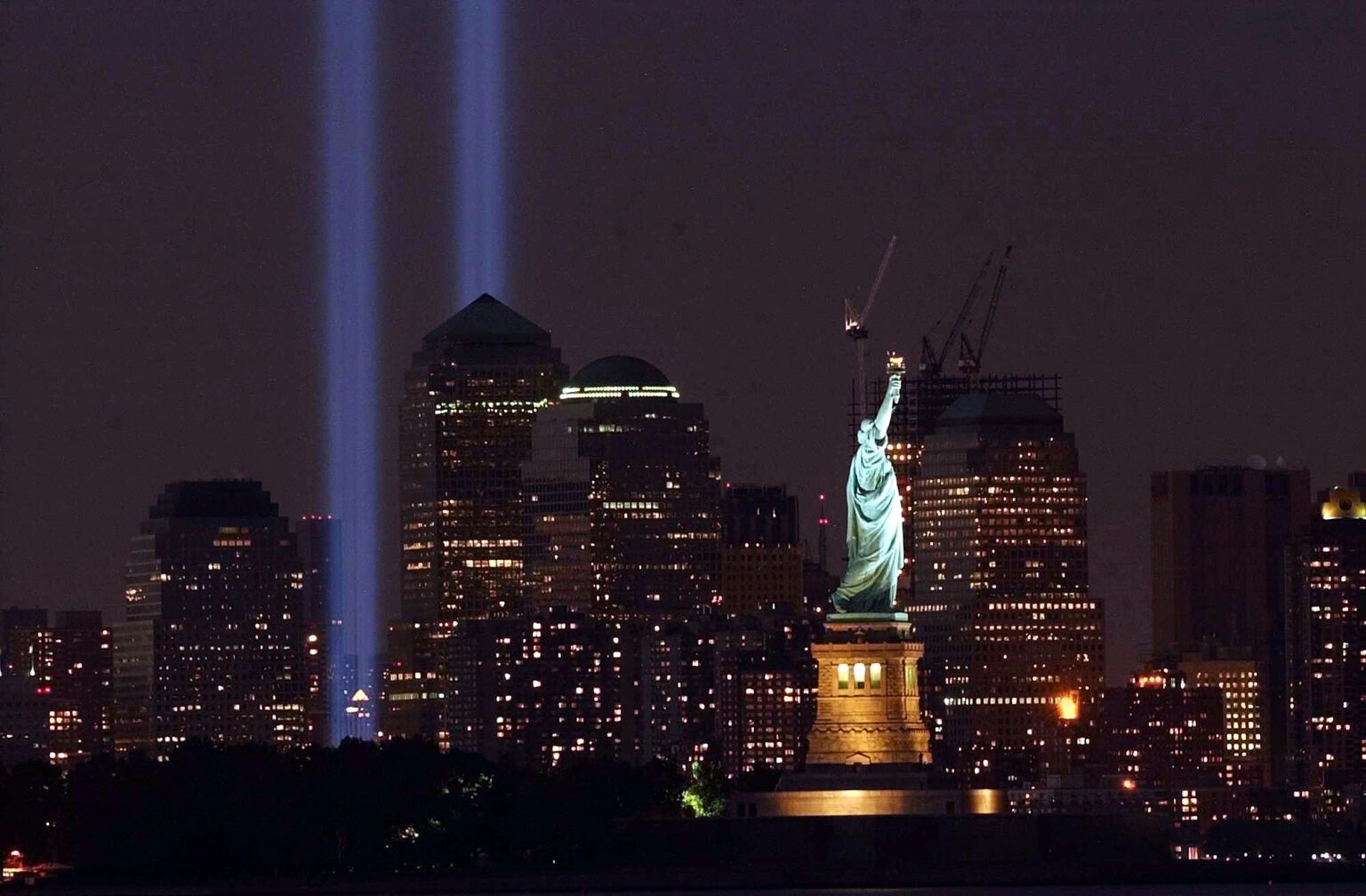 Two light beams illuminate the sky in memorial of the Sept. 11 attacks on New York's World Trade Center Saturday, Sept. 11, 2004, as shown from Jersey City, N.J. (AP Photo/Brian Branch-Price) AP Photo/Brian Branch-Price