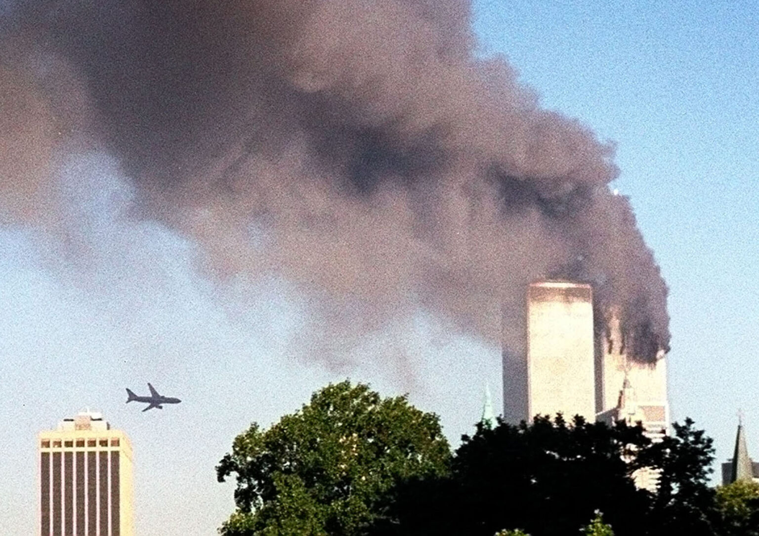 FILE- In this Sept. 11, 2001 file photo, American Airlines Flight 175 closes in on World Trade Center Tower 2 in New York, just before impact. Families of the victims of the worst terror attack on the United States in history gathered Wednesday, Sept. 11, 2013, to mark their 12th anniversary with a moment of silence and the reading of names. The Sept. 11, 2001 attacks in New York City and Washington killed almost 3,000 people and lead to a war in Afghanistan. (AP Photo/William Kratzke) AP Photo/William Kratzke