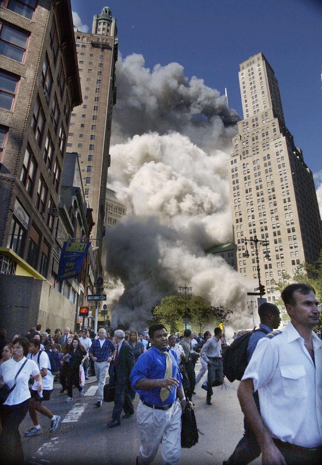 Pedestrians flee the area of the World Trade Center as the center's south tower collapses following a terrorist attack on the New York landmark Tuesday, Sept. 11, 2001. (AP Photo/Amy Sancetta) AP Photo/Amy Sancetta