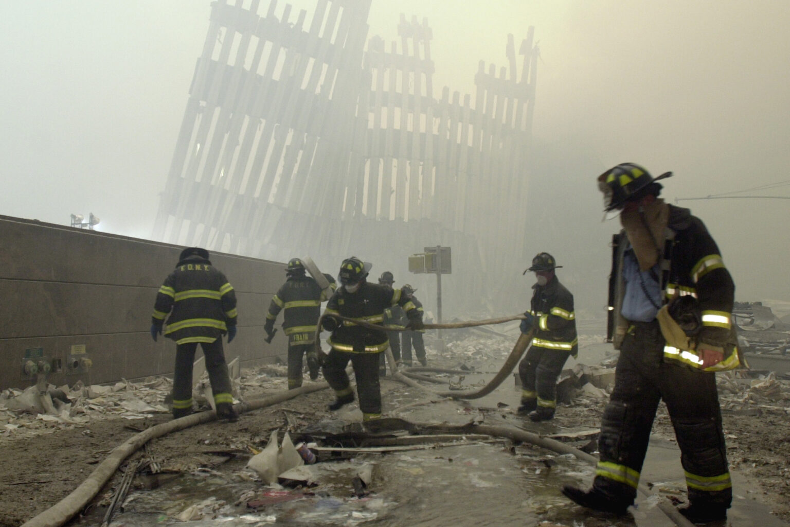 FILE - In this Sept. 11, 2001, file photo, firefighters work beneath the destroyed mullions, the vertical struts that once faced the outer walls of the World Trade Center towers, after a terrorist attack on the twin towers in New York. Sept. 11 victims’ relatives are greeting the news of President Donald Trump’s now-canceled plan for secret talks with Afghanistan’s Taliban insurgents with mixed feelings. (AP Photo/Mark Lennihan, File) AP Photo/Mark Lennihan, File