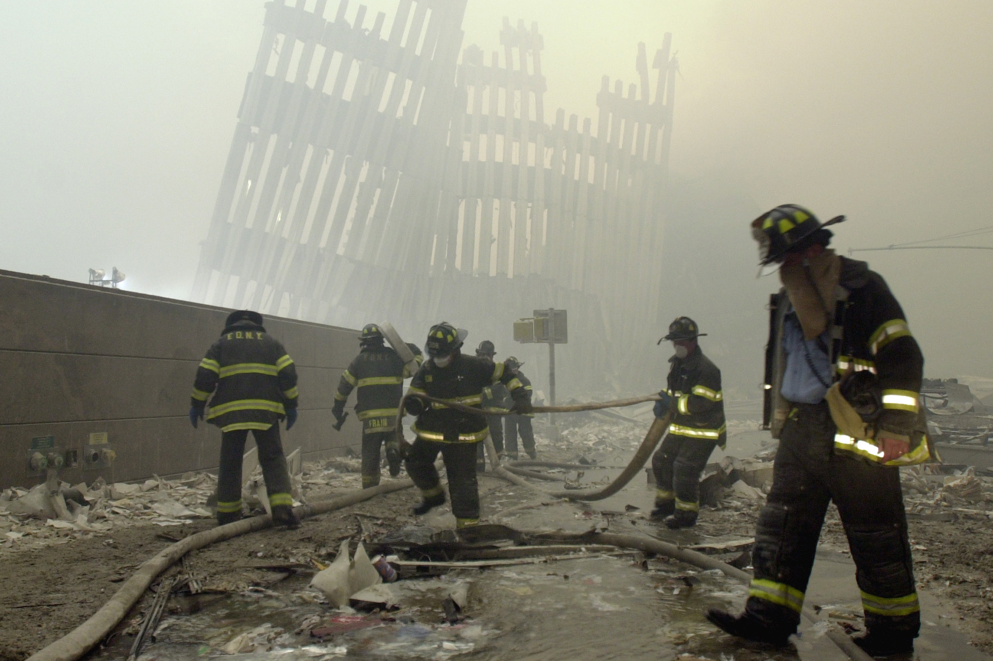 File - In This Sept. 11, 2001, File Photo, Firefighters Work Beneath The Destroyed Mullions, The Vertical Struts That Once Faced The Outer Walls Of The World Trade Center Towers, After A Terrorist Attack On The Twin Towers In New York. Sept. 11 Victims’ Relatives Are Greeting The News Of President Donald Trump’s Now-Canceled Plan For Secret Talks With Afghanistan’s Taliban Insurgents With Mixed Feelings. (Ap Photo/Mark Lennihan, File) Ap Photo/Mark Lennihan, File