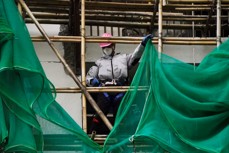 Hong Kong s’efforce de retirer les filets d’échafaudage accusés d’avoir alimenté un incendie meurtrier